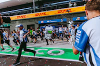 a group of people walking on a track with confetti