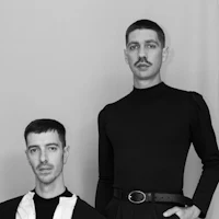 two men posing for a photo in black and white