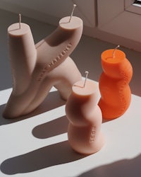 three candles are sitting on a table next to each other