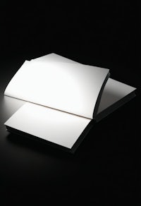 a white book with a light shining on it