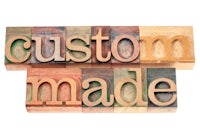 the word custom made in wooden blocks on a white background