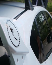 a white car with a palm tree on the hood