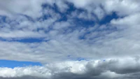a blue sky with clouds in the background