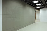 a room with a white wall and a drawing on it