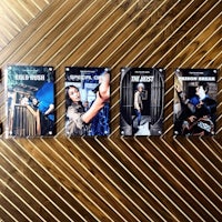 a set of four movie posters on a wooden table