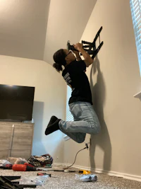 a woman jumping up and down on a wall