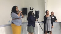 a group of people standing in front of a microphone