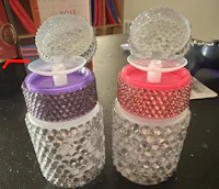 two plastic bottles with a lid on them