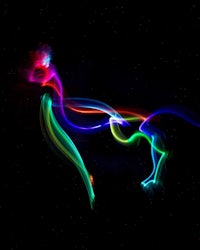 a colorful light painting of a horse on a black background