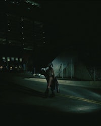 a person walking down a street at night