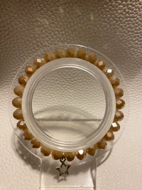 a clear mirror with a bead on it