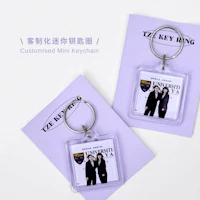 two keychains with a picture of a man and a woman