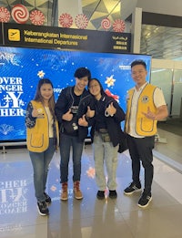 a group of people posing for a photo in an airport