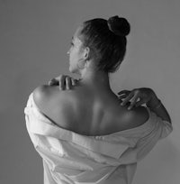 a woman in a white shirt with her back to the camera