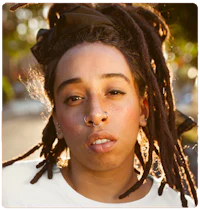 a young woman with dreadlocks and piercings
