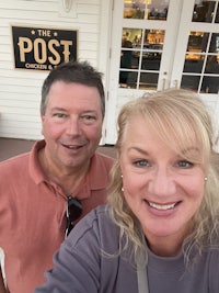 a man and a woman taking a selfie in front of a building
