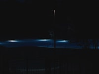 a pool lit up at night