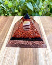 a pyramid with red seeds on top of it