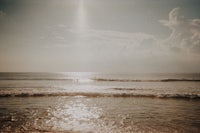 the sun is shining on the water