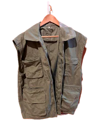 a green vest hanging on a hanger