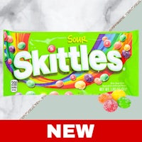 a bag of skittles on a marble table