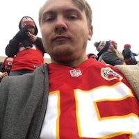 a man wearing a kansas chiefs jersey