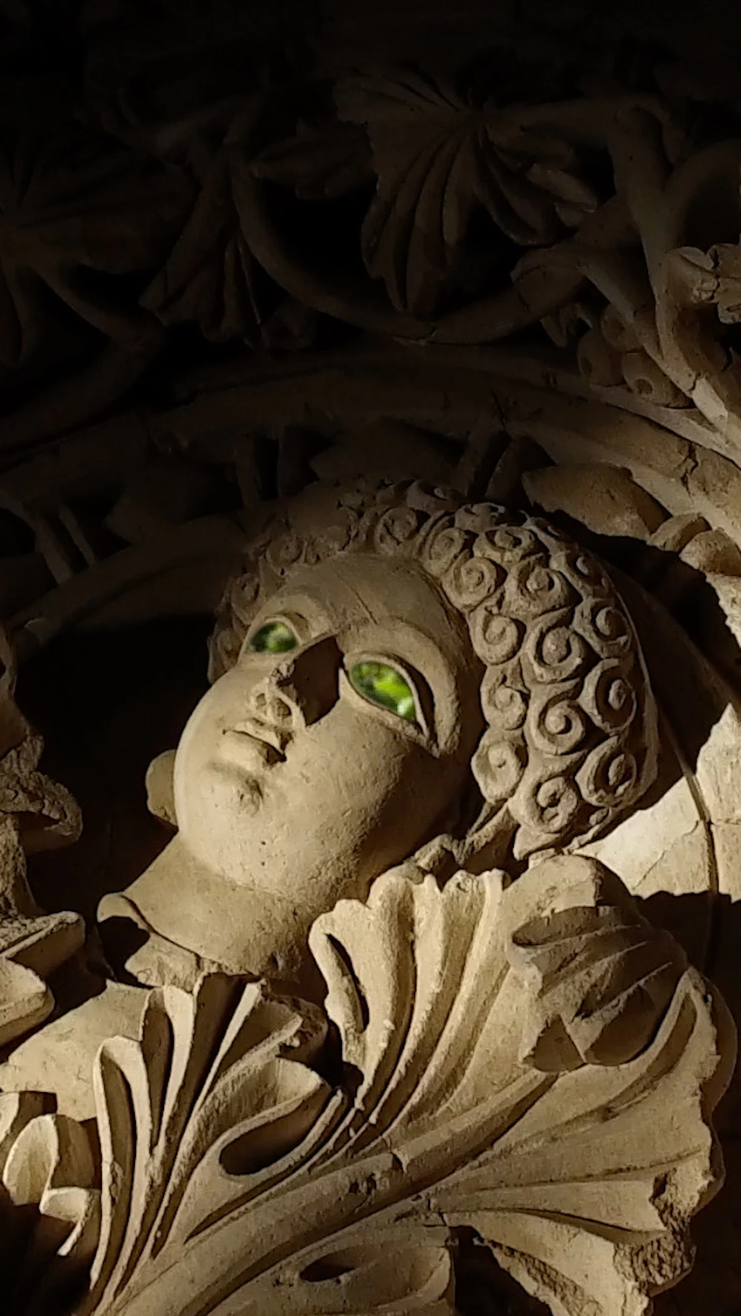 a statue of a woman with green eyes