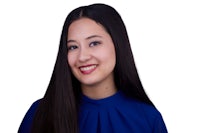 a young woman in a blue shirt smiling