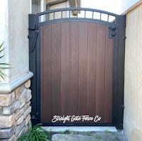 a wooden gate in front of a house