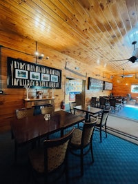 a dining room with tables and chairs in a log cabin
