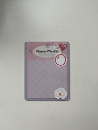 a notepad with a pink flower on it