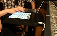 a man is using a laptop in a recording studio