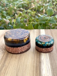 two glass jars sitting on top of a wooden table