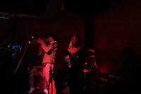 a group of people playing music in a dark room