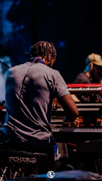 a man playing a keyboard at a concert