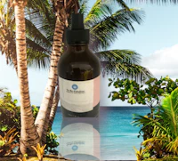 a bottle of coconut oil with palm trees in the background