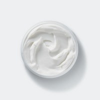 a white cream in a bowl on a white background