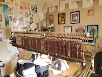 a room with a loom hanging on the wall