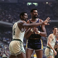 two basketball players standing next to each other