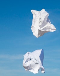 two white paper bags flying in the air