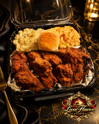 a tray with fried chicken, mashed potatoes and gravy