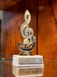 the music award trophy is on display in a glass case
