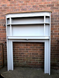 a fireplace with a shelf on top of it