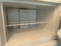 the inside of a refrigerator with the door open
