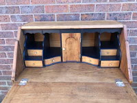 an old wooden desk with drawers on it