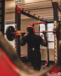 a man lifting a barbell in a gym
