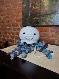 a crocheted octopus sitting on a table