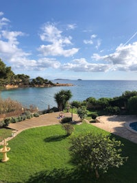 an aerial view of a house with a pool and ocean view