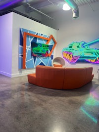 a room with a couch and a tank on the wall