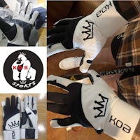 a pair of black and white gloves with a crown on them